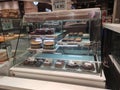 A variety of decorative cakes are placed on a glass chiller rack to make it easier for customers to choose.