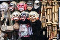 Variety of decorative masks made of wood hanging from the ceiling at a market in Ubud, Indonesia