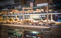 Variety of delicious breads displayed on shelves in bakery shop, Bangkok, Thailand