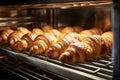 A variety of delicious croissants neatly arranged on a rack, ready to be enjoyed, fresh croissants in rack in bakery oven, AI