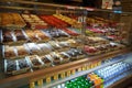 Variety of delicious donut in showcase on display at bakery cake shop Krispy Kreme. Various donuts type on shelf in Bakery shop.