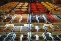 Variety of delicious donut in showcase on display at bakery cake shop Krispy Kreme. Various donuts type on shelf in Bakery shop.