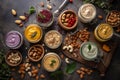 Processing nuts into vegan sauces and cheeses A variety of different flavors of hummus are on a table. AI generation