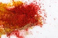 Variety of different ground spices in powder peppers paprika turmeric spilled in explosion effect on white marble stone background Royalty Free Stock Photo