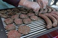 Variety of different kind of meat steaks, meatballs, shish kebab, fillet, burgers and sausages with bread on a grill outdoor. Gril Royalty Free Stock Photo