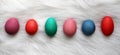 Variety of Different Size and Color Easter Eggs Lined up on Whit