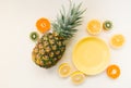 Variety of Different Tropical Seasonal Summer Fruits. Citrus Oranges Pineapple Lemons on White Background with pastel yellow trend Royalty Free Stock Photo