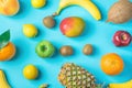 Variety of Different Tropical and Seasonal Summer Fruits. Pineapple Mango Coconut Oranges Lemons Apples Kiwi Bananas Scattered Royalty Free Stock Photo