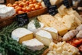 A variety of different types of cheese on a wooden table Royalty Free Stock Photo