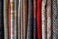 A variety of different types of fabric neatly arranged in rows at a store, Emulate the textures and patterns of various fabrics Royalty Free Stock Photo