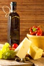Variety of different vegetables,with glass bottle and cheese
