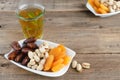 Dried fruit tray with tea glass on wooden background. Copy space Royalty Free Stock Photo
