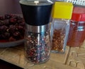 Containers of english pepper, chili flakes, paprika and dried re