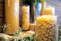 Variety of dry pasta macaroni,fusilli,shapes of Italian pasta in glass jars,set of many different pasta types,short hollow fluted Royalty Free Stock Photo