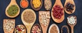 Variety of dry uncooked legumes on wooden spoons, banner