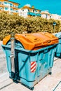 Variety dumpstersrecycling containers  on a city street Royalty Free Stock Photo