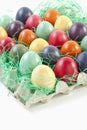 Variety of Easter eggs in egg carton on white background Royalty Free Stock Photo