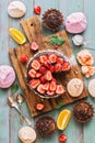 A variety of festive sweets-cupcakes, chocolate cake with strawberries, meringue on a green wooden rustic background. Flat lay Royalty Free Stock Photo