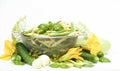 Variety of first green vegetables and herbs: cucumber, green string bean, basil, zucchini, dill, onion and yellow flowers Royalty Free Stock Photo