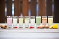 variety of flavored eggnogs in individual shot glasses