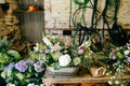 Variety of flowers in wooden backets. Bouquetes standing on wooden table. Composition with flowers with pleasant smell. Decoration