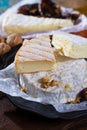 French soft cheeses - camembert, marcaire, munster, brie - delicious dessert with nuts and dried fruits