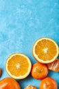 Variety of fresh citrus fruits for making juice or smoothie over blue textured background, top view, selective focus. Royalty Free Stock Photo