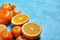 Variety of fresh citrus fruits for making juice or smoothie over blue textured background, top view, selective focus. Royalty Free Stock Photo