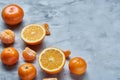 Variety of fresh citrus fruits for making juice or smoothie over light textured background, top view, selective focus. Royalty Free Stock Photo