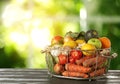 Variety of fresh delicious vegetables and fruits in basket on table against blurred background, space for text Royalty Free Stock Photo