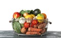 Variety of fresh delicious vegetables and fruits in basket on table against white Royalty Free Stock Photo