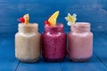 Variety of Fresh Healthy Paleo Smoothies and Cocktails in Rainbow Colors on Blue Wooden Background