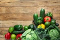 Variety Fresh Organic Green Vegetables Savoy Cabbage Zucchini Cucumbers Red Yellow Bell Peppers Avocados on Weathered Plank Wood Royalty Free Stock Photo