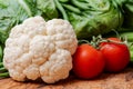 A variety of fresh raw Organic Vegetables including Cauliflower and Tomatoes on the vine.