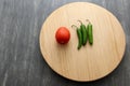 Variety of fresh vegetables in basket and chopping board ready to cook a Mexican sauce: onion, tomato, green chilies Royalty Free Stock Photo