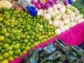 Variety of fresh vegetables on surface with pink cloth at stall in mexican market Royalty Free Stock Photo
