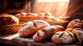 A variety of freshly baked bread on a wooden bakery table.