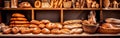 A variety of freshly baked bread on a wooden bakery table.