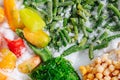 Variety of frozen berries, greens and veggies on a grinded ice. top view. Royalty Free Stock Photo