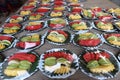 Variety of Fruit Catering in plastic wrap to serve on wooden table with reflect on plastic high constrast