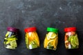 Variety of fruit infused detox water in jars for a healthy diet top view on a dark background Royalty Free Stock Photo