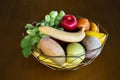 Variety fruits in aluminum basket on wooden table in dining room of restaurant cafe coffee shop for thai people and travelers Royalty Free Stock Photo