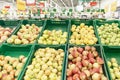 A variety of fruits in boxes in a large hypermarket. Healthy eating and vegetarianism