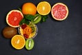 Variety of fruits grapefruit, oranges, kiwi, lemon, mint bunched together on a shale board, the concept of healthy eating, copy sp