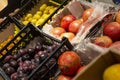 A variety of fruits in plastic containers in the store. Side view Royalty Free Stock Photo