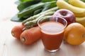 A variety of fruits and vegetables and a glass of vegetable juice