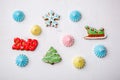 Variety of gingerbreads and meringue on a white vintage background, flat lay, top view. Holiday sweets. New Year and Christmas the