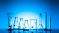 Variety of glass flasks and lab equipment on a blue ba Royalty Free Stock Photo