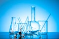 Variety of glass flasks and lab equipment on a blue background Royalty Free Stock Photo