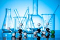 Variety of glass flasks and lab equipment with molecule structures on a table Royalty Free Stock Photo